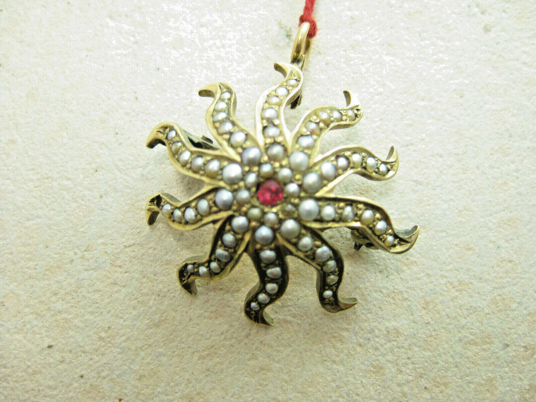 g264 beautiful 14kt Gold Starburst Brooch with Seed Pearls and a Center Ruby