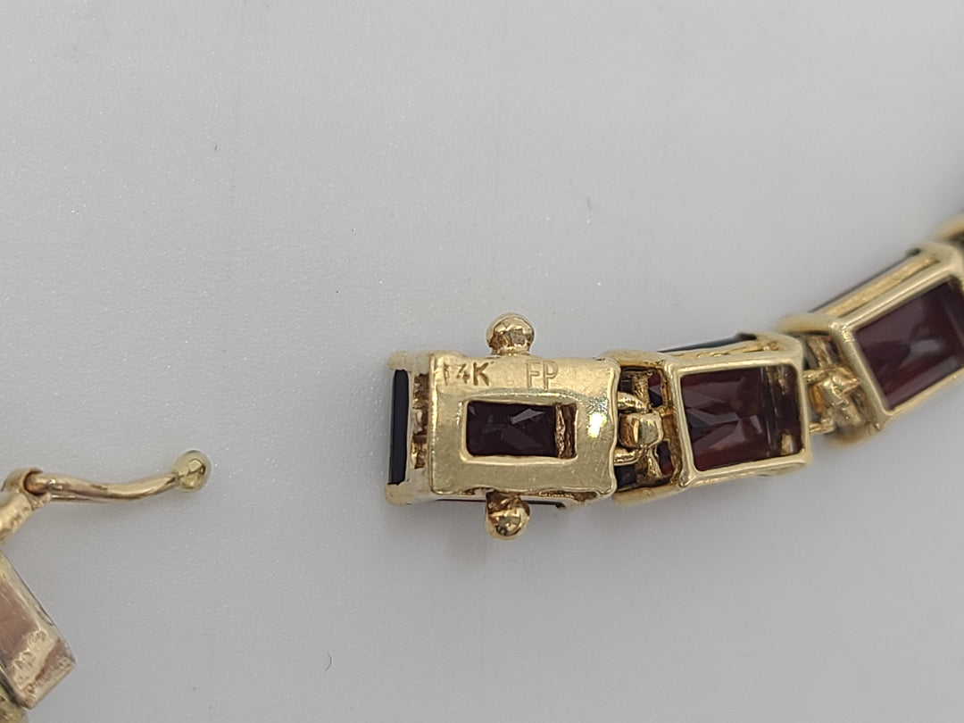 k775 Lovely Lady's 7 1/8" Garnet Bracelet in 14kt Yellow Gold