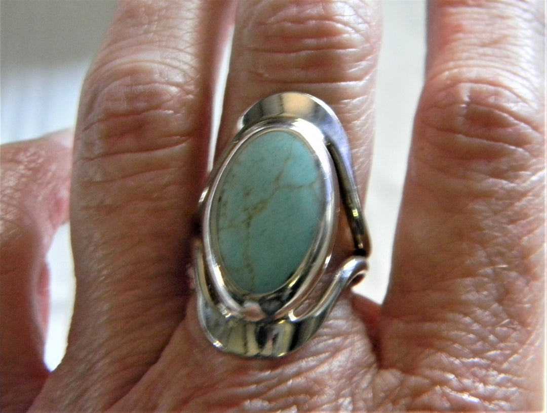 h954 Sterling Silver Ring with Bezel set Oval Turquoise in a Silver Frame