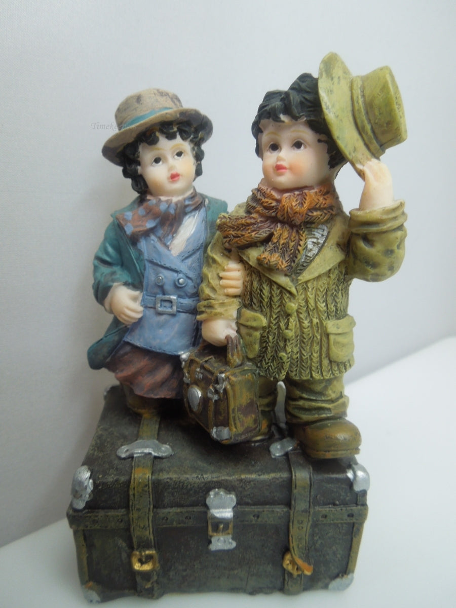 q741 Vintage Collectible Figurine Boy and Girl Standing on Trunk Suitcase