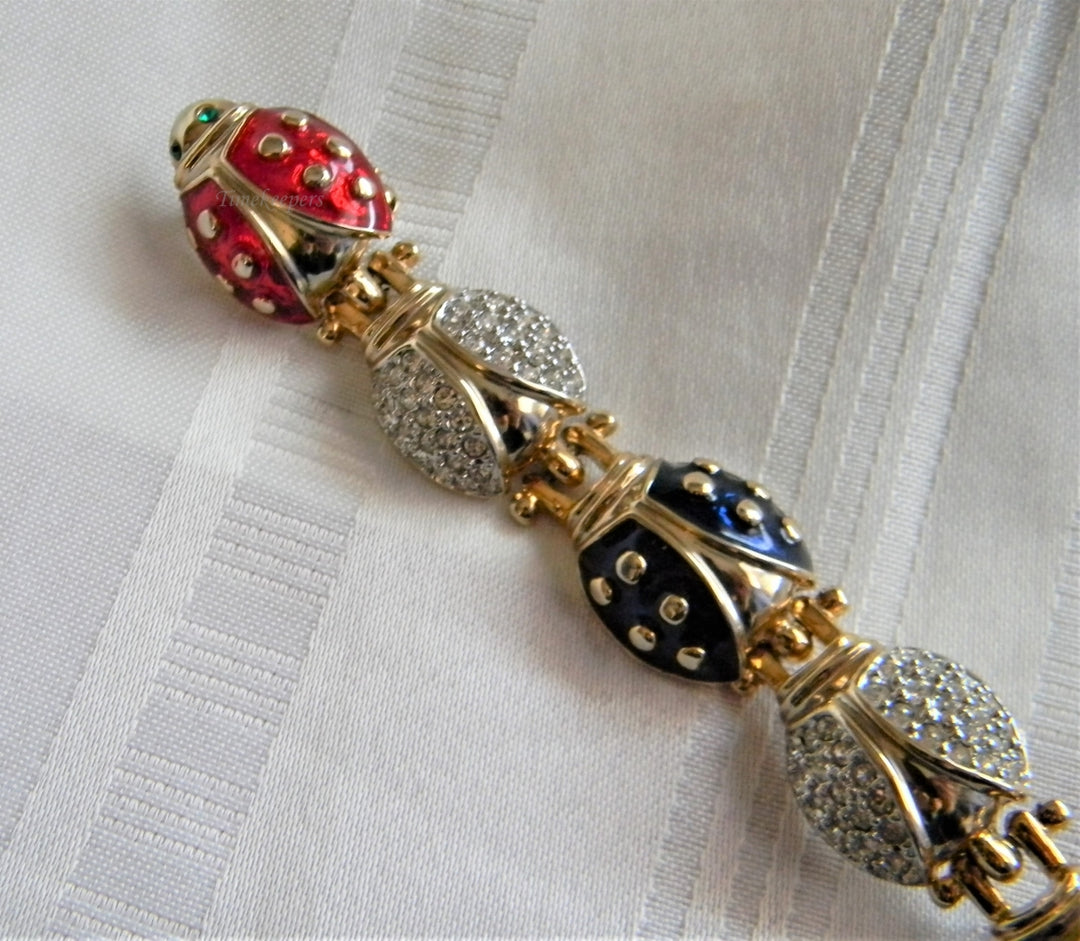 p038 Unique Long Lady Bug Pin with (7) Bugs Trailing Each Other In Gold Tone