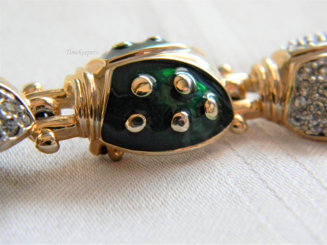 p038 Unique Long Lady Bug Pin with (7) Bugs Trailing Each Other In Gold Tone