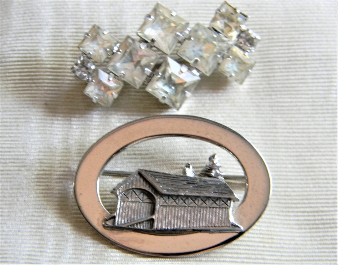 p328 Pair of Vintage Brooches, Rhinestone and Covered Bridge in Silver Tone