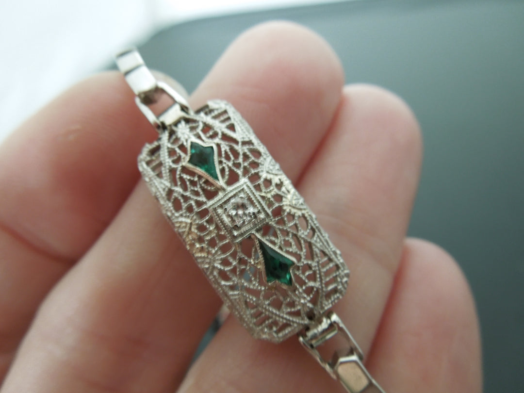 g427 Elegant Small Sized Bracelet that Features 2 Emeralds and a .05cts Diamond