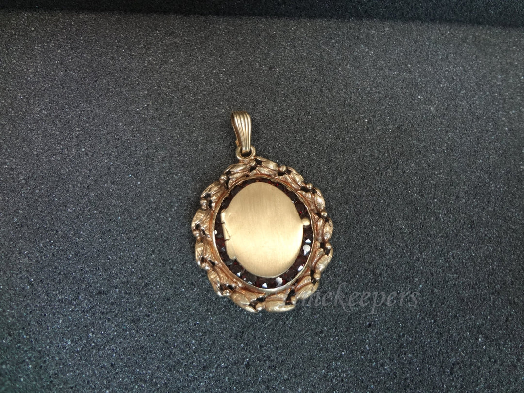 a726 Beautiful 14k yellow gold Oval shaped Locket Surrounded by Garnets