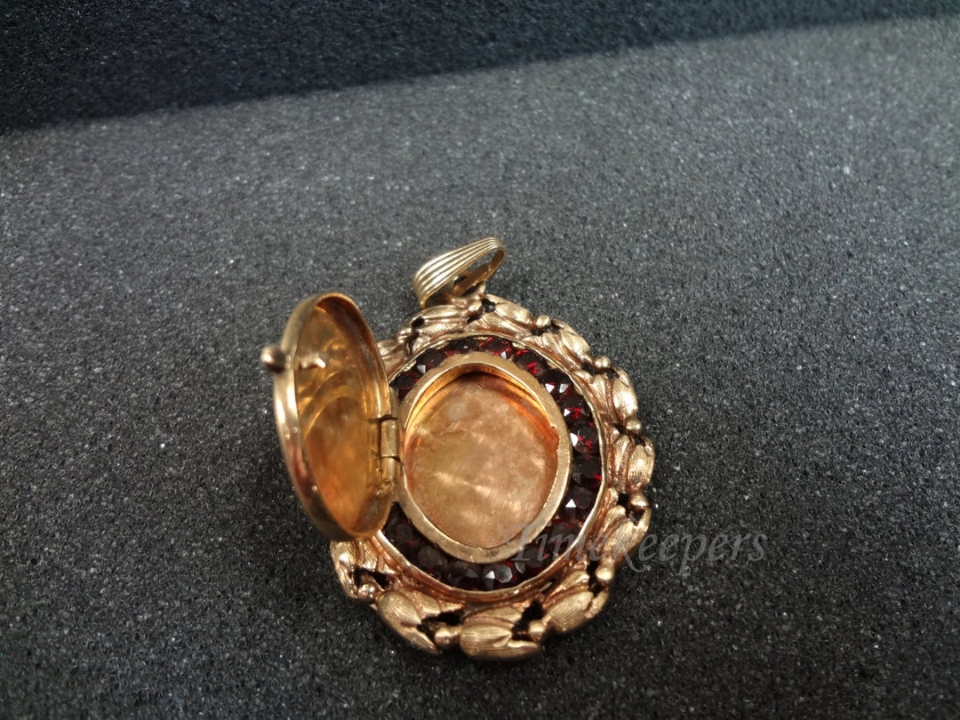 a726 Beautiful 14k yellow gold Oval shaped Locket Surrounded by Garnets